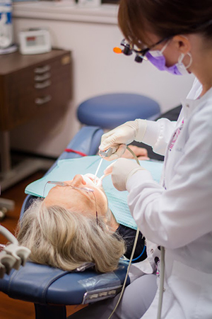 patient receiving dental treatment with advanced technology