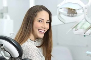 a patient smiling after her teeth whitening procedure